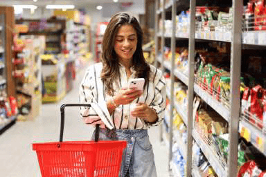 A shopper with a red daves basket in store